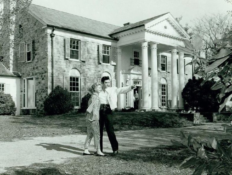 Elvis and a female friend outside his home Graceland in 1957