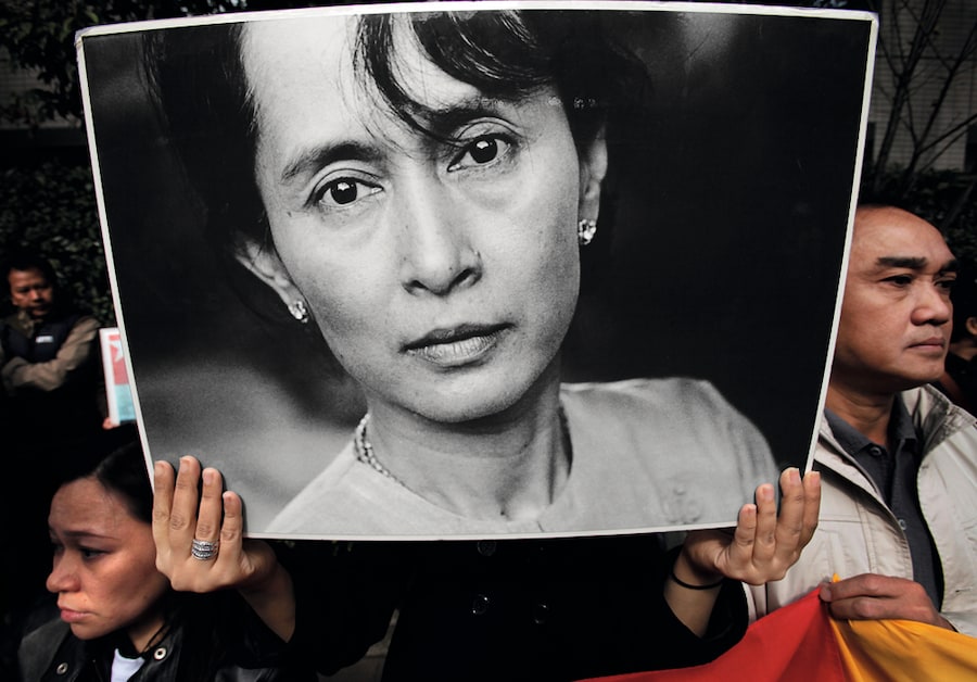 Poster of Aung San Suu Kyi held by supporter