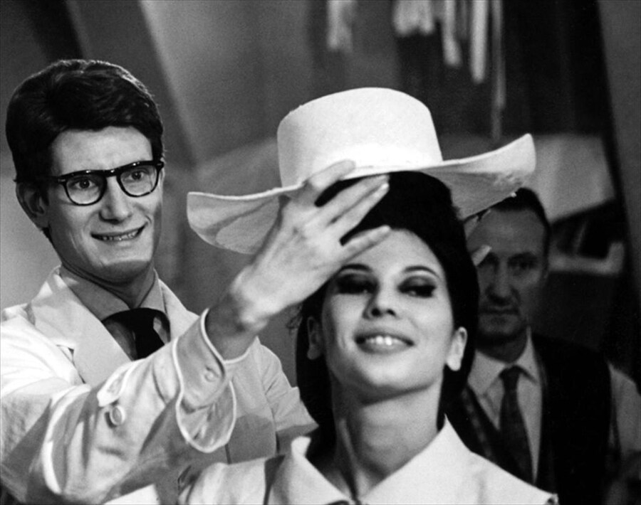 Yves Saint Laurent adjusting a model&#39;s hat