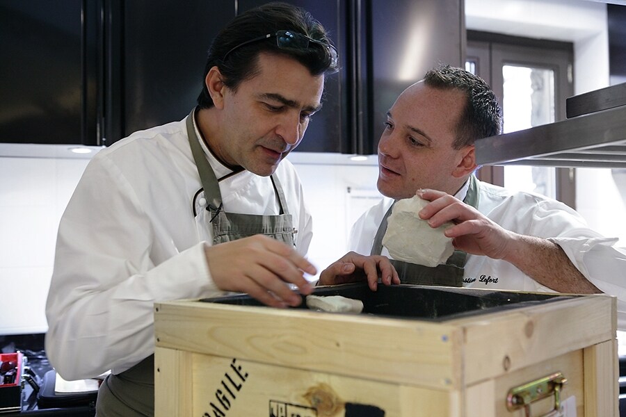 Yannick All&#233;no and a member of his team examine chalk from t