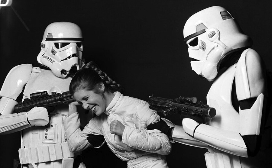 Carrie Fisher and two Stormtroopers in The Empire Strikes Ba