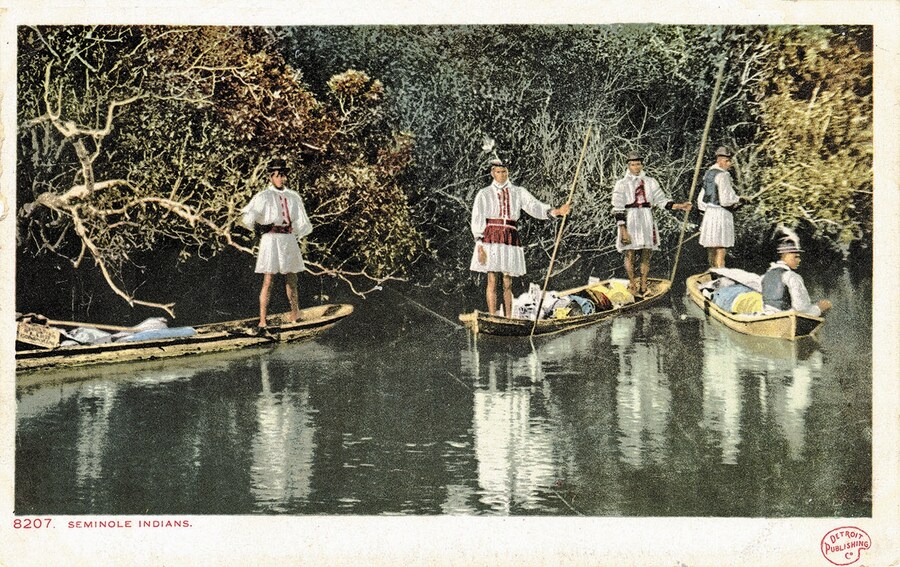 Seminole Indian family in dugout canoe, Miami River, Florida