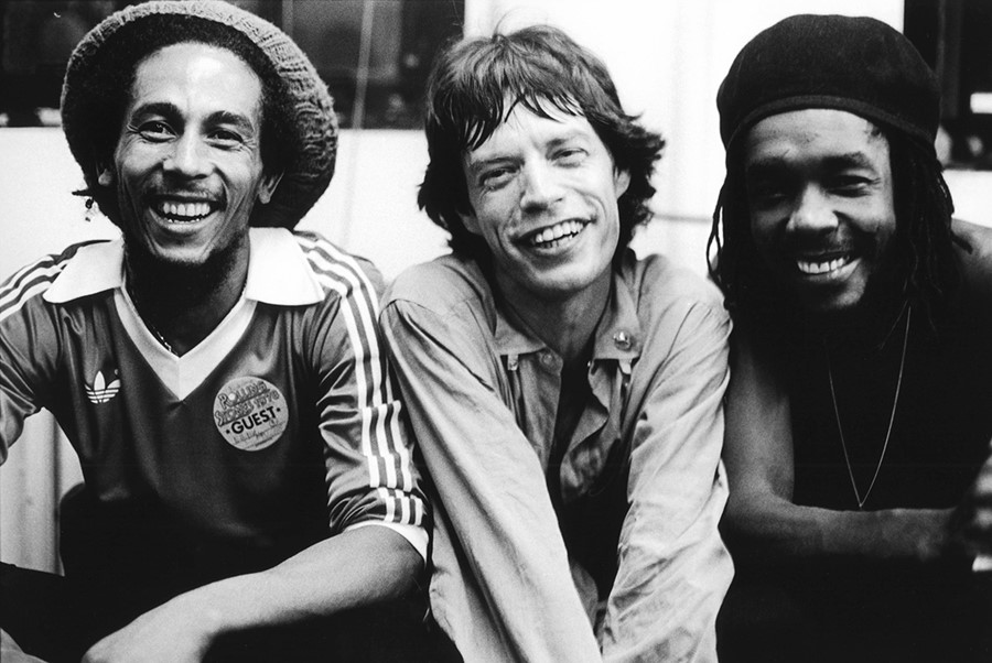 Bob Marley, Mick Jagger and Peter Tosh pose backstage at a R