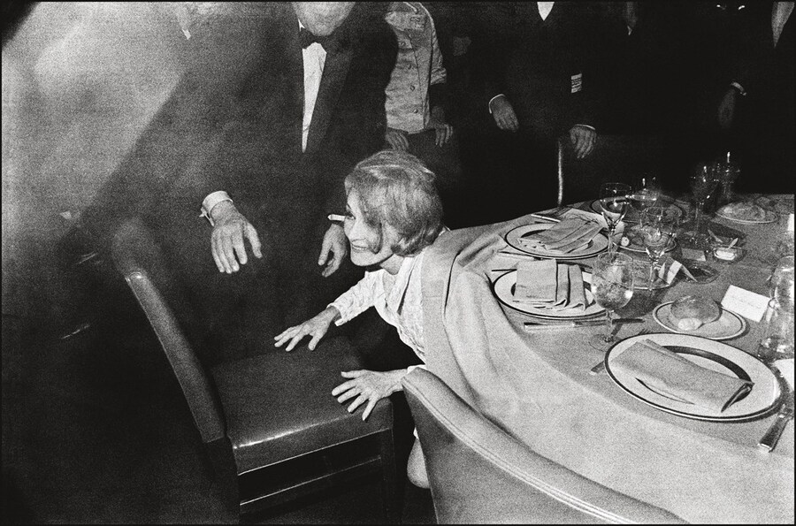 Marlene Dietrich emerging from beneath the table