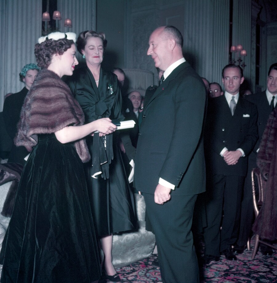 Princess Margaret presents Christian Dior with a s
