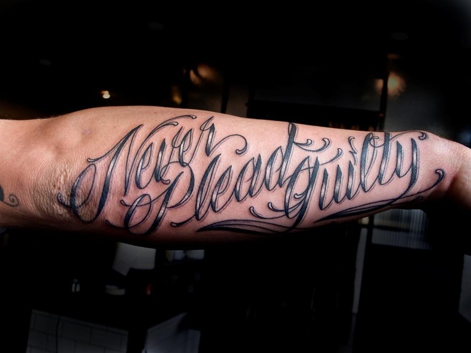 Never Plead Guilty Tattoo by Scott Cambell